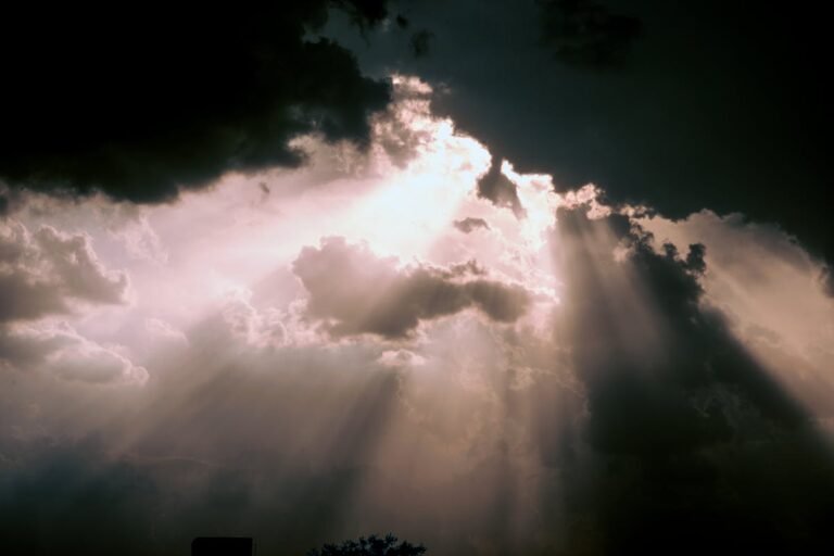 Rays of sunlight breaking through dark storm clouds - the battle for your mind